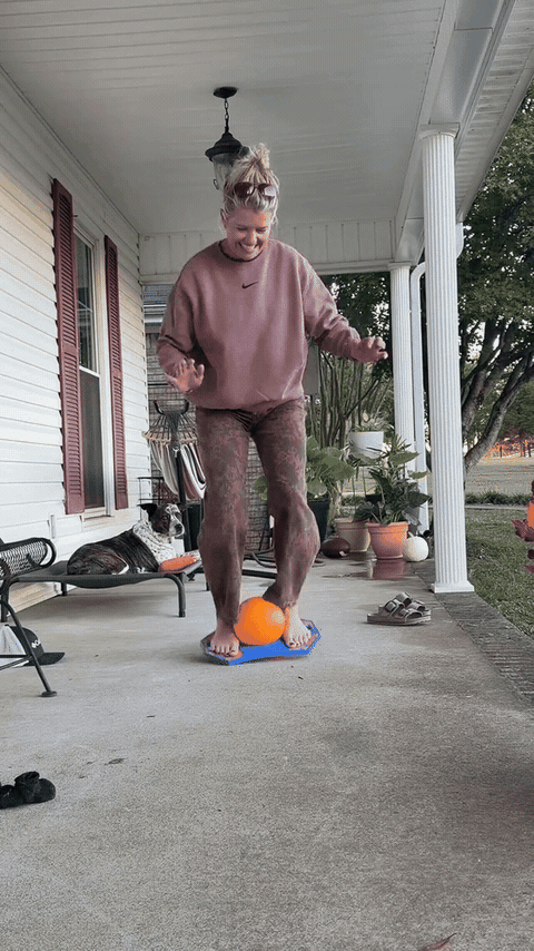 Bouncing and balancing on a JumpOrb board outdoors